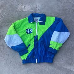 Vintage 1980s PPG Oshawa Windbreaker Jacket - Size S (Length 24", Chest 21") - Flaws pictured - Message for more information Please take note of the measurements listed as these are vintage clothes and may fit different than the tag size. Follow our page for more vintage clothing drops! DISCLAIMER: All items are vintage so please be mindful that if by chance there is a flaw on the item we simply may have just missed it. Inquire for more product information. Retro Blue Windbreaker For Spring, Retro Green Color Block Outerwear, Retro Blue Windbreaker For Fall, Blue Retro Track Jacket For Spring, 90s Style Blue Patchwork Outerwear, 90s Patchwork Blue Outerwear, 90s Blue Patchwork Outerwear, Blue Retro Windbreaker For Fall, Retro Cotton Color Block Outerwear