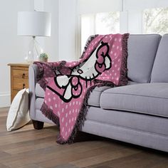 a couch with a hello kitty blanket on it