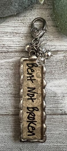 a keychain with the words rock and roll written in black ink on it