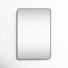 a square mirror mounted on the wall