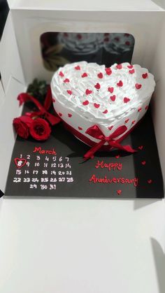 a heart shaped cake in a white box