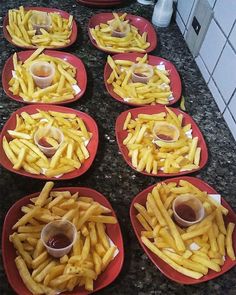 red plates with french fries and ketchup on them