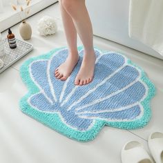 a person standing on top of a bath mat