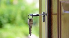 an open door with a bunch of keys hanging from it's side and outside