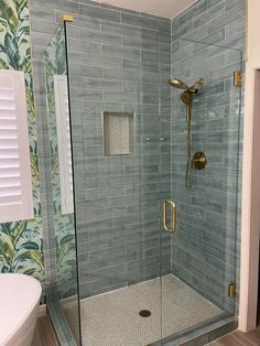 a walk in shower sitting inside of a bathroom