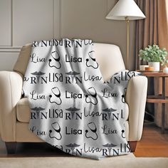 a living room with a couch and chair covered in a blanket that says i love you