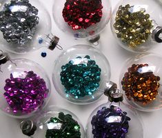 there are many different colored beads in glass balls