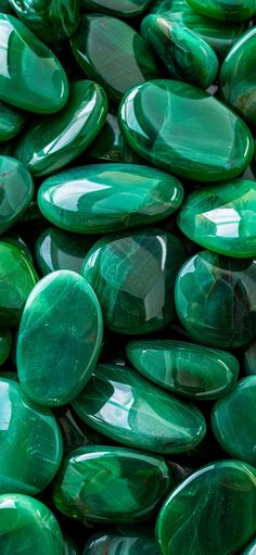 many green stones are stacked on top of each other in this close up photo,