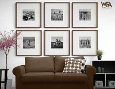 a living room filled with furniture and framed pictures on the wall above it's coffee table