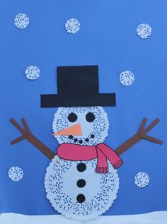 a snowman made out of paper on a blue background with white polka dot dots