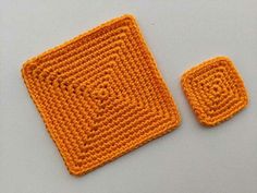 an orange crocheted square with two smaller squares on the top and one small square at the bottom