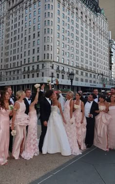 a group of people standing in front of a tall building