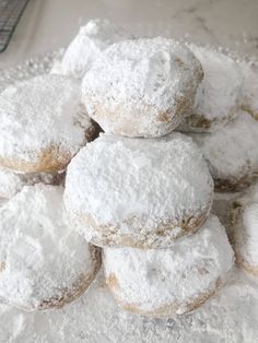 a pile of powdered donuts sitting on top of each other