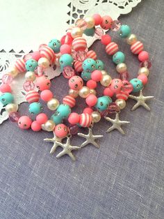 several different colored beads and starfish charms