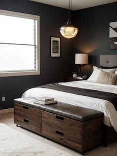 a bedroom with black walls and white bedding