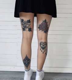 a woman's legs with tattoos on them