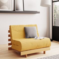 a living room with a yellow couch and pictures on the wall