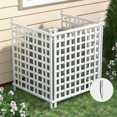 a white trellis planter sitting in the grass