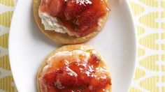 two strawberry shortcakes with whipped cream on top are sitting on a white plate