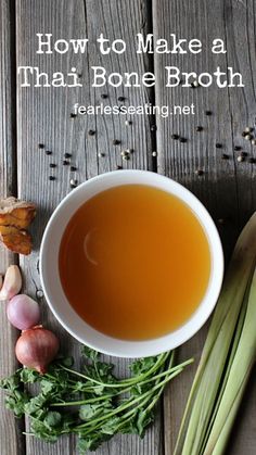 a bowl filled with broth next to some vegetables