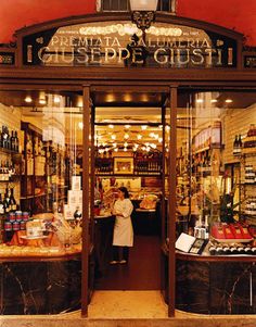 a woman is standing in the doorway of a store