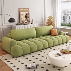 a green couch sitting on top of a white rug