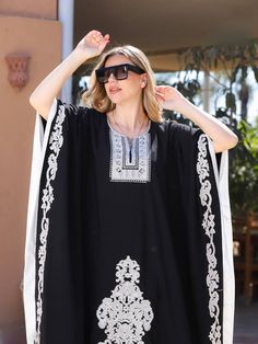 "Elegant embroidered Black plus size Kaftan, Loose fit Bohemian Caftan, Cotton Kaftan, Exotic Kaftan, Cotton Caftans for women This beautiful Moroccan butterfly Kaftan has a unique presence to it. It's elegant and most importantly comfortable wear, light and soft and can be used on many occasions - home gatherings, dinners, or just in your home to feel comfortable. Fabric : 80% Egyptian Cotton and 20% Polyester Measurements : Free size. Fits up to 6XL. Also there is a belt that can be used to tighten the dress around the hips. Bust size : 98 inches Length : 55 inches For reference, the model is 5'6\" and a size 4 US (Small). Since it's a free size dress, it fits her quite loosely and will be more fitted on bigger sizes. >> Shipping times<< We ship all orders with DHL within one to two busi Floral Embroidered Kaftan For Beach Cover-up, Summer Kaftan With Intricate Embroidery, Resham Embroidery Tunic Abaya, Free Size Tunic Abaya, Maxi Length Kaftan With Intricate Embroidery, Beach Kaftan With Intricate Embroidery, Resham Embroidery Kaftan For Vacation, Beach Kaftan With Chikankari Embroidery, Embroidered Abaya For Festival