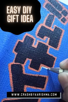 a person is using a marker to draw the word easy diy gift idea on a piece of fabric