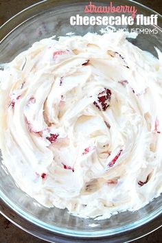 a bowl filled with cream cheese and strawberries