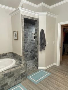 a bath room with a walk in shower