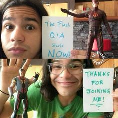 two people holding up signs and posing for the camera with one man in front of them