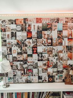 a book shelf filled with lots of books next to a wall covered in many different pictures