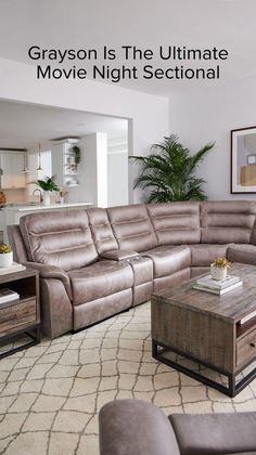 a living room filled with furniture and a large sectional couch in front of a window