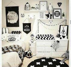 a bedroom decorated in black and white with pictures on the wall