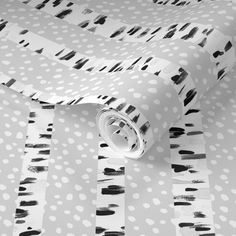 black and white polka dot wrapping paper on top of a tablecloth covered with dots