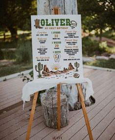 a sign that is on top of a wooden easel in front of a tree