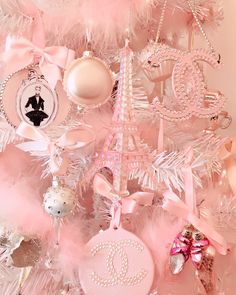 a pink christmas tree decorated with ornaments and baubles for the paris eiffel tower