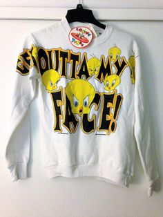 a white sweatshirt with yellow faces on it that says,'squatta my face '