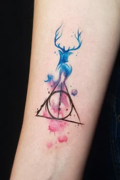 a watercolor tattoo on the arm of a person with an antelope design