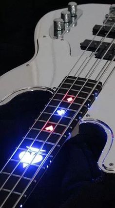 an electric bass guitar with red, white and blue lights