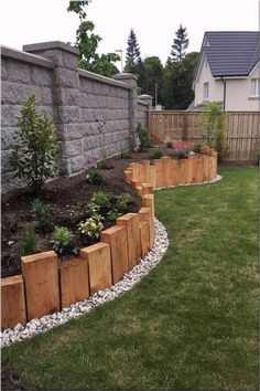 a garden with rocks and wooden planters