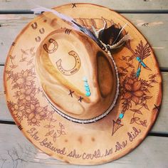 "This hand burned ranchers hat features a trail of horseshoes, a decorative feather & arrow crossing with turquoise details and a cluster of detailed flowers.  Our hats are perfect for your wedding, honeymoon, photoshoot, day/night out, any occasion you can think of!  With easy clean up all you need is a dry or damp cloth and gently wipe your hat.  These hats are extremely durable and will keep their shape. All our hats are fully customizable so please feel free to add or remove any designs. All Western Hat Bands For Wedding And Kentucky Derby, Bohemian Hat Bands For Kentucky Derby Wedding, Bohemian Short Brim Hats For Wedding, Custom Adjustable Wedding Hats, Western Wide Brim Wedding Hat, Western Style Wedding Hat With Flat Brim, Western Flat Brim Wedding Hat, Western Style Flat Brim Wedding Hat, Bohemian Adjustable Hat Bands For Wedding