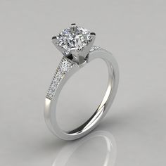 a diamond engagement ring on a gray background