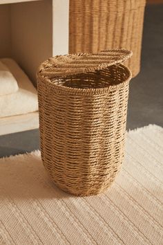 a woven basket sitting on top of a rug