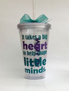 a plastic cup with a green bow on the top that says it takes a big heart to help manage little minds