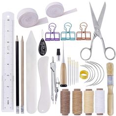 sewing supplies and tools displayed on white background