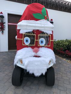 a santa clause costume is on display in front of a house with lights and decorations