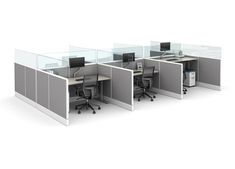 an office cubicle with three desks and two monitors on each side, all separated by privacy screens