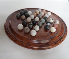 a wooden tray with marbles on it