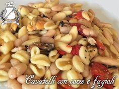 pasta with mushrooms, tomatoes and peppers on a white plate in front of the words cavalli con coze e fagaglii